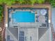 Aerial view of the screened pool with lounge furniture and solar panels at 3637 Chandler Estates Dr, Apopka, FL 32712