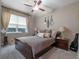 Cozy bedroom featuring ceiling fan, guitar decor, and bedside tables with lamps, creating a relaxing atmosphere at 3637 Chandler Estates Dr, Apopka, FL 32712
