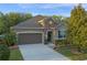 Beautiful home featuring a two-car garage, brick accents, and meticulously maintained landscaping at 3637 Chandler Estates Dr, Apopka, FL 32712