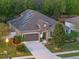 Charming one-story home with solar panels, manicured lawn, beautiful landscaping, and inviting stone entryway at 3637 Chandler Estates Dr, Apopka, FL 32712