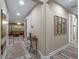 Inviting hallway with decorative console table, art, and a glimpse into the cozy living room at 3637 Chandler Estates Dr, Apopka, FL 32712