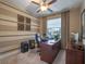 Functional home office with large desk, comfortable chair, and natural light creating a productive workspace at 3637 Chandler Estates Dr, Apopka, FL 32712