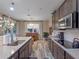 Spacious kitchen with stainless appliances and a view to the pool through sliding glass doors at 3637 Chandler Estates Dr, Apopka, FL 32712