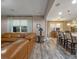 Spacious living room features wood-look floors, comfortable leather seating, open to dining and kitchen area at 3637 Chandler Estates Dr, Apopka, FL 32712