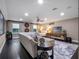 Spacious living room features dark floors, plush seating, and ample lighting at 3637 Chandler Estates Dr, Apopka, FL 32712