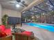 Cozy covered patio area with ample seating, perfect for relaxing and enjoying views of the screened-in pool at 3637 Chandler Estates Dr, Apopka, FL 32712