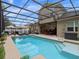 Backyard oasis: screened-in pool with ample seating and lush tropical greenery at 3637 Chandler Estates Dr, Apopka, FL 32712