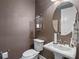 Chic powder room with patterned wallpaper and modern fixtures at 3637 Chandler Estates Dr, Apopka, FL 32712