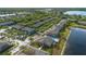 Community aerial view showcasing residences, lush landscaping, and a community pool with lake views at 3664 Wilshire Way Rd # 261, Orlando, FL 32829