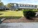 Townhouse backyard featuring a grass lawn and landscaping at 3664 Wilshire Way Rd # 261, Orlando, FL 32829