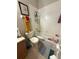 A well-lit bathroom features a tub with tiled walls, a framed print, and a variety of colorful decor at 3664 Wilshire Way Rd # 261, Orlando, FL 32829