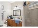 View of the bathroom showcasing a vanity, mirror, lighting fixtures, and walk-in shower at 3664 Wilshire Way Rd # 261, Orlando, FL 32829