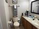 Compact bathroom featuring a vanity and toilet with coordinated decor and accessories at 3664 Wilshire Way Rd # 261, Orlando, FL 32829