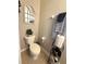 Charming half-bath with an arched mirror and well-organized towel and toilet paper storage at 3664 Wilshire Way Rd # 261, Orlando, FL 32829