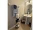 Cozy half-bath featuring a pedestal sink, decorative storage rack, and stylish towel display at 3664 Wilshire Way Rd # 261, Orlando, FL 32829