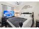 This bedroom features a black four-poster bed, black dresser, and modern light fixture at 3664 Wilshire Way Rd # 261, Orlando, FL 32829