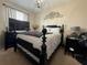 Elegant bedroom with a decorative headboard, dark wood furniture and neutral wall décor at 3664 Wilshire Way Rd # 261, Orlando, FL 32829