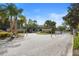 Gated community entrance featuring brick paved road and manicured landscaping at 3664 Wilshire Way Rd # 261, Orlando, FL 32829