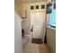 Welcoming foyer with tiled flooring, a white door and a 'welcome' sign at 3664 Wilshire Way Rd # 261, Orlando, FL 32829