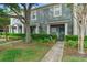 Charming two-story townhome featuring well-maintained landscaping, a welcoming entrance, and mature trees at 3664 Wilshire Way Rd # 261, Orlando, FL 32829