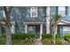 Exterior elevation of a blue townhome with tidy landscaping and sidewalk at 3664 Wilshire Way Rd # 261, Orlando, FL 32829