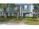 Exterior elevation of a blue townhome with green door and tidy landscaping at 3664 Wilshire Way Rd # 261, Orlando, FL 32829