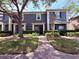 Charming two-story townhome featuring well-maintained landscaping, a welcoming entrance, and mature trees at 3664 Wilshire Way Rd # 261, Orlando, FL 32829