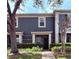 Charming two-story townhome featuring well-maintained landscaping, a welcoming entrance, and mature trees at 3664 Wilshire Way Rd # 261, Orlando, FL 32829