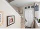 View of hallway with stairs, a white door and decorated beige walls at 3664 Wilshire Way Rd # 261, Orlando, FL 32829