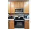 Well-lit kitchen with stainless steel appliances and light wood cabinets at 3664 Wilshire Way Rd # 261, Orlando, FL 32829