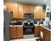 The kitchen features stainless steel appliances, wooden cabinets, ample counter space, and a functional layout at 3664 Wilshire Way Rd # 261, Orlando, FL 32829