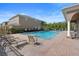 Community pool with lounge chairs and well-maintained landscaping on a sunny day at 3664 Wilshire Way Rd # 261, Orlando, FL 32829
