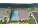 Aerial view of a community pool with lounge chairs and a nearby parking area at 3664 Wilshire Way Rd # 261, Orlando, FL 32829