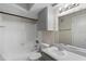 Bathroom featuring a tiled shower-tub combination, vanity, and overhead cabinet storage at 4355 Perkinshire Ln # 103, Orlando, FL 32822