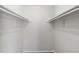 Clean and spacious walk-in closet with rods for organizing clothes and other belongings at 4355 Perkinshire Ln # 103, Orlando, FL 32822