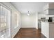 Bright dining area features wood floors, a modern light fixture and easy access to the kitchen and outside through sliding doors at 4355 Perkinshire Ln # 103, Orlando, FL 32822