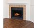 Close up of the fireplace, with black surround and tile accents, providing warmth and a focal point in the living space at 4355 Perkinshire Ln # 103, Orlando, FL 32822
