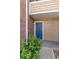 Exterior shot of a blue apartment door with siding and a light fixture above the entrance at 4355 Perkinshire Ln # 103, Orlando, FL 32822