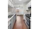 Galley kitchen has stainless steel appliances, ample counter space, and sight lines into dining room at 4355 Perkinshire Ln # 103, Orlando, FL 32822