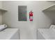Neat laundry area with modern appliances, an electrical panel, and a fire extinguisher at 4355 Perkinshire Ln # 103, Orlando, FL 32822