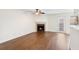 Spacious living area includes wood floors, neutral paint, a fireplace, and a sliding glass door that leads to the outside at 4355 Perkinshire Ln # 103, Orlando, FL 32822