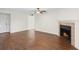 Living room features wood floors, neutral paint, and a cozy fireplace with a black surround and tile accents at 4355 Perkinshire Ln # 103, Orlando, FL 32822