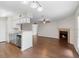 Spacious living room features a fireplace, ceiling fan, and sightlines into the kitchen at 4355 Perkinshire Ln # 103, Orlando, FL 32822