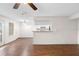 Open-concept living room with vinyl floors and view into the kitchen, providing a comfortable living space at 4355 Perkinshire Ln # 103, Orlando, FL 32822