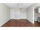 Neutral living room with wood floors offers access to a bathroom and bedroom at 4355 Perkinshire Ln # 103, Orlando, FL 32822