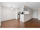 Living room includes vinyl floors and an open-concept view to the kitchen and entrance to the condo at 4355 Perkinshire Ln # 103, Orlando, FL 32822