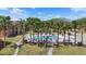 Community pool surrounded by palm trees, offering a refreshing oasis for residents at 4355 Perkinshire Ln # 103, Orlando, FL 32822