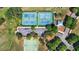 Overhead shot of community tennis and basketball courts surrounded by lush trees and parking at 4718 Magnetite Loop, Mount Dora, FL 32757