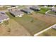 Aerial view of the property, showcasing a large, well-maintained lot with a house and green lawn at 4718 Magnetite Loop, Mount Dora, FL 32757