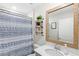 Bathroom featuring a single sink, vanity, decorative mirror, and a patterned shower curtain at 4718 Magnetite Loop, Mount Dora, FL 32757